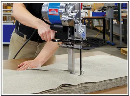 Pew cover material being cut to size